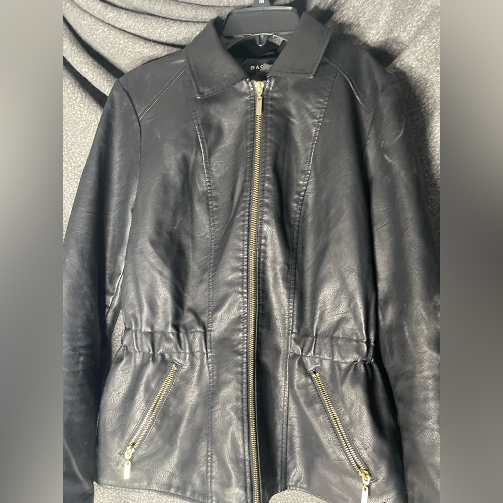 It’s a really cute leather jacket. It’s black with gold zipper.
